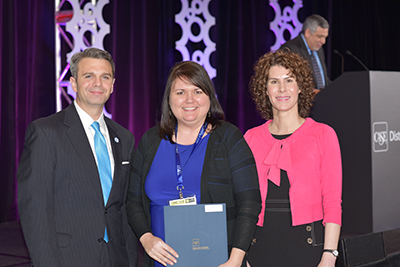 Misty McMillan receives award from CASE representatives in Atlanta.