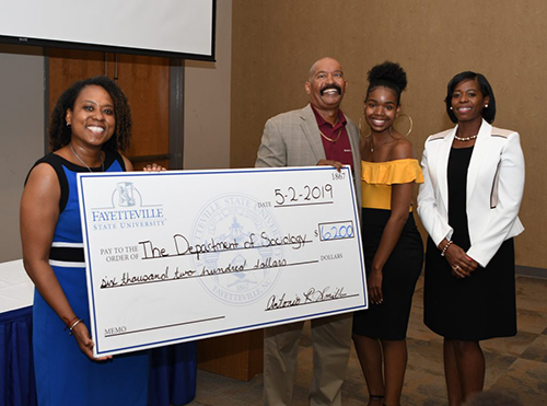 Father presents check to Department of Sociology