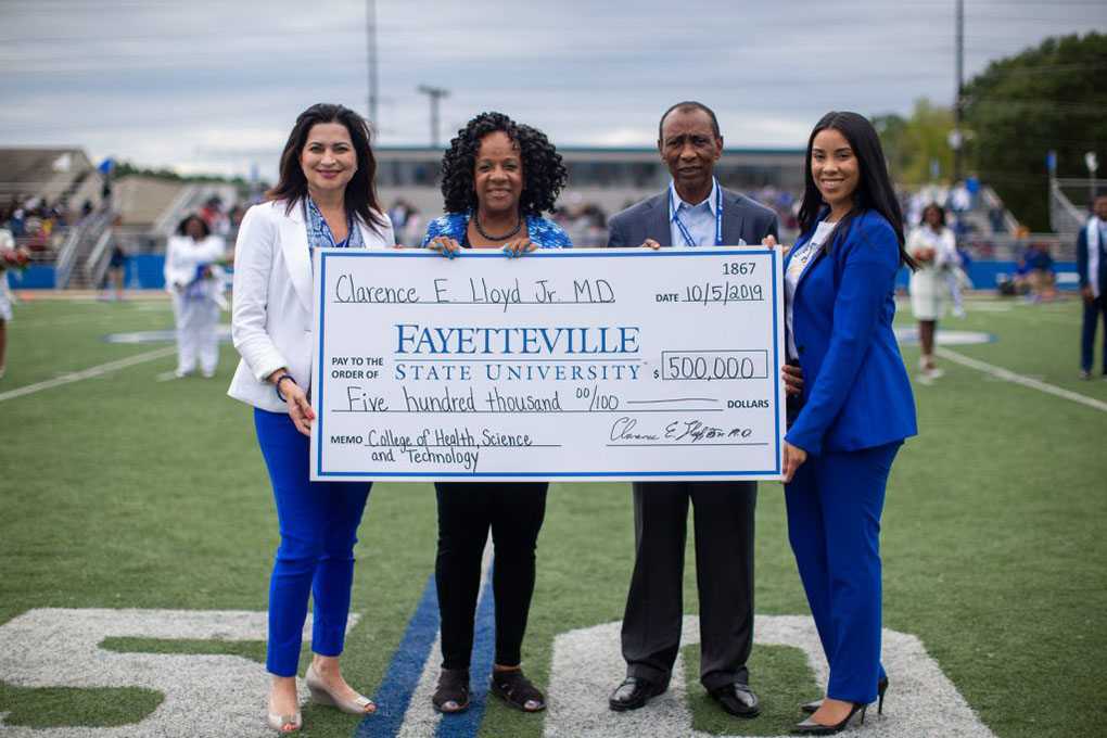 Dr. Clarence Lloyd, second from right, presents Fayetteville State University Interim Chancellor Peggy Valentine, second from left, a check for $500,000. Also pictured from left are Lorna Ricotta, Vice Chancellor for Institutional Advancement, and Jalisha Pone, Associate Director of Development.